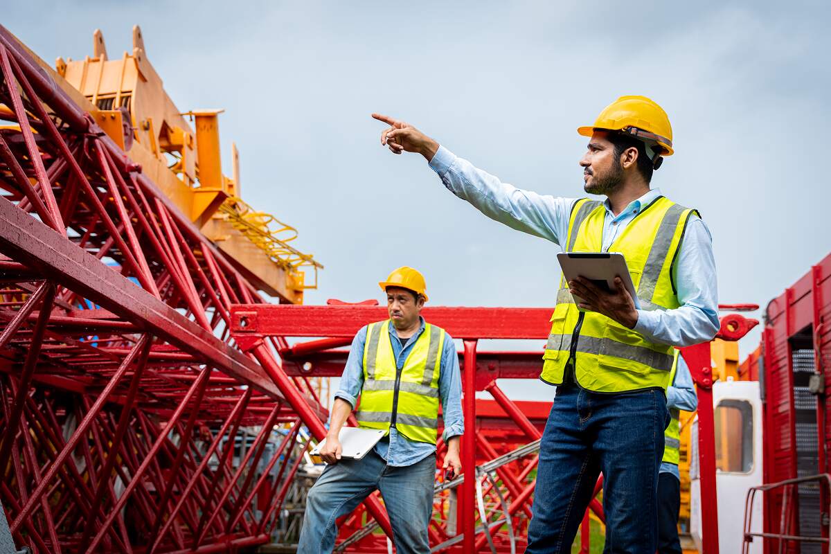 three-men-in-construction-gear-are-talking-to-each-DMTHQZK.jpg